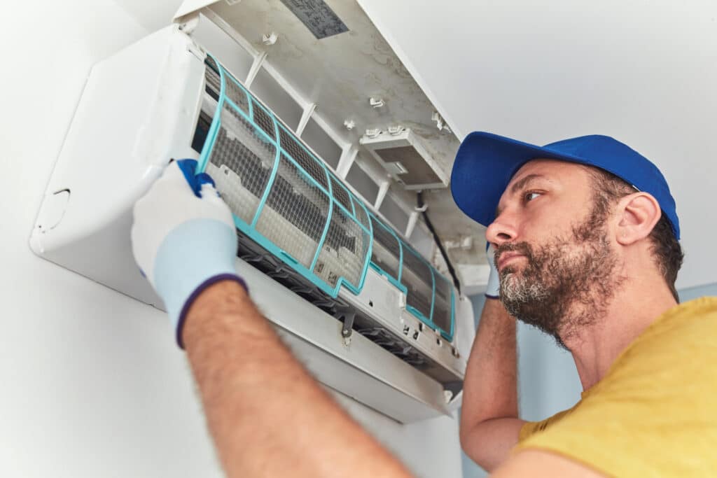 HVAC technician repairing a residential mini split unit